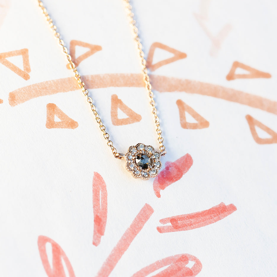 Handmade everyday layering necklace featuring salt and pepper rose cut diamond surrounded by vintage inspired diamond and beading halo in 18K yellow gold by Designer Megan Thorne