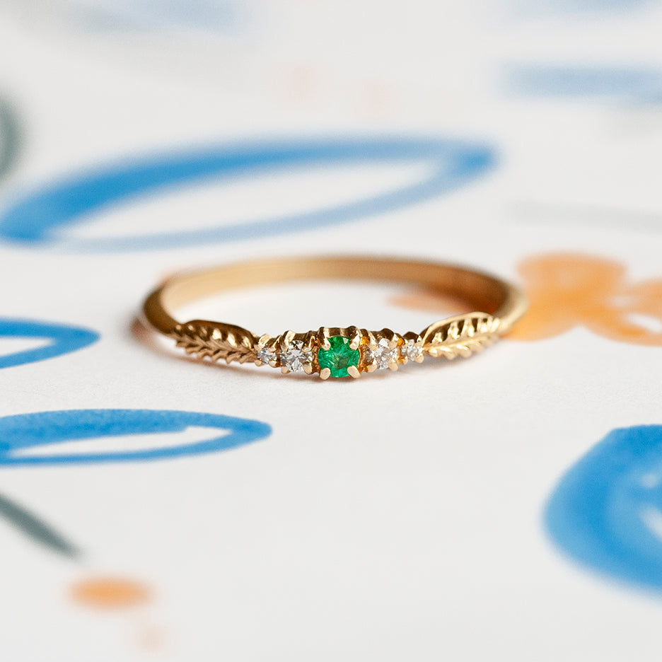Handmade wedding or stacking band with diamonds and emerald and botanical inspired Evergreen details in 18K yellow gold by Designer Megan Thorne