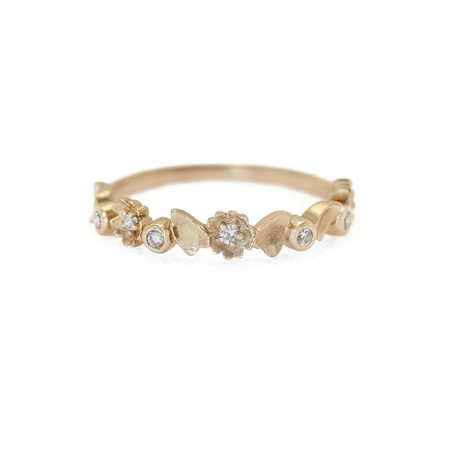 Handmade half eternity wedding band with buttercup floral details and diamonds set in 18K yellow gold by Designer Megan Thorne