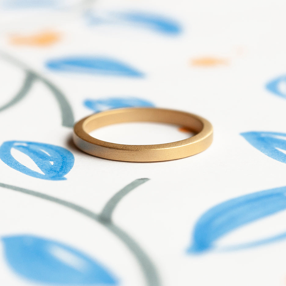 Handmade classic thin plain stacking or wedding band in 18K yellow gold by Designer Megan Thorne