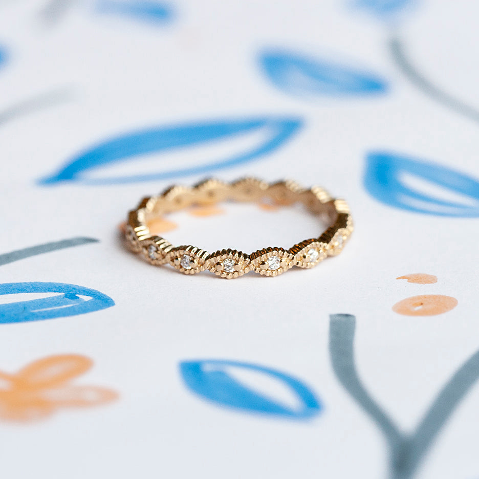 Handmade thin eternity wedding band or stacking ring with diamonds and geometric ribbed scallops in 18K yellow gold by Designer Megan Thorne