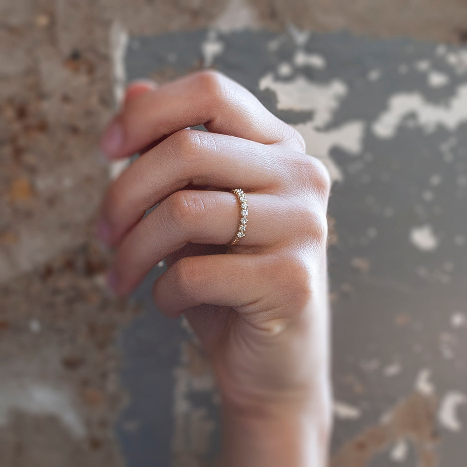 Handmade wedding or stacking band with single cut diamonds and Evergreen botanical details in 18K yellow gold by Designer Megan Thorne on hand