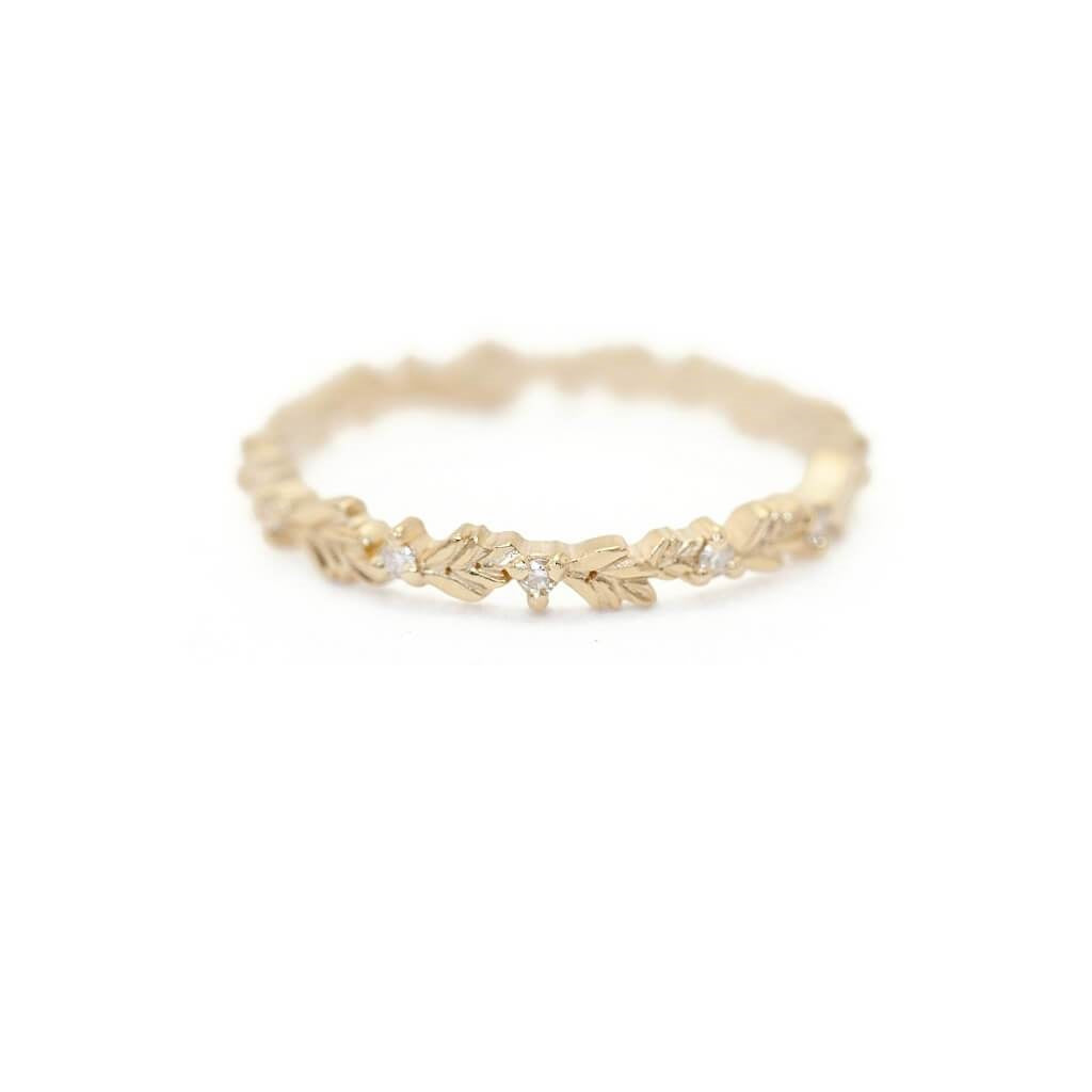 Handmade thin eternity wedding band or stacking ring featuring diamonds and hand carved floral Wood Nymph details in 18K yellow gold by Designer Megan Thorne