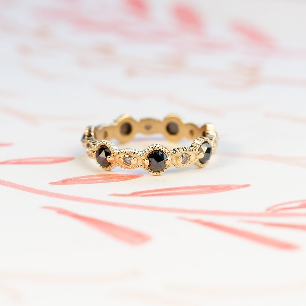 Handmade wedding or stacking band with black diamonds and salt and pepper diamond accents with ribbing and scallops in 18K yellow gold by Designer Megan Thorne 